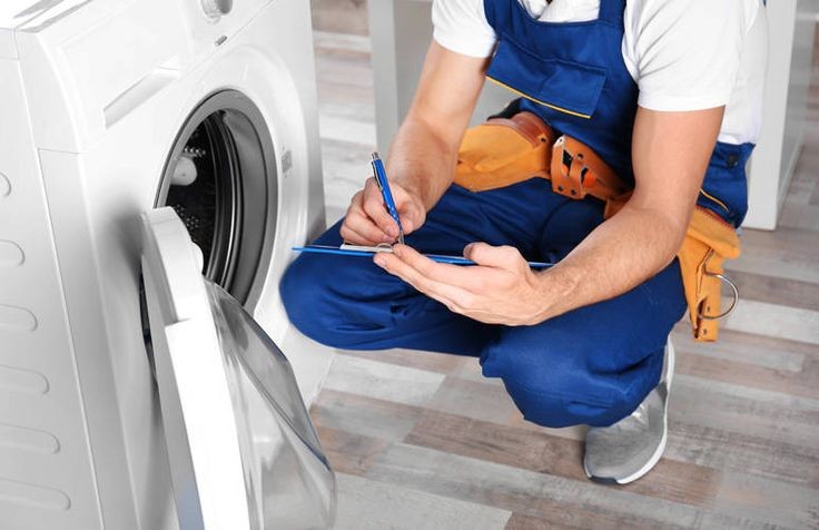dryer repair technician checking dryer