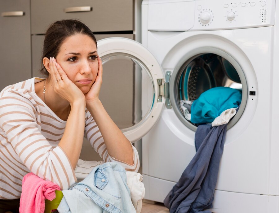 stressed woman doing laundry