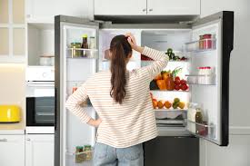 woman infront of fridge