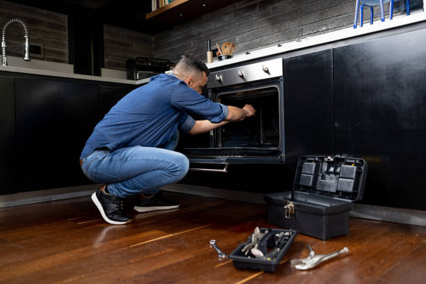 technician fixing oven