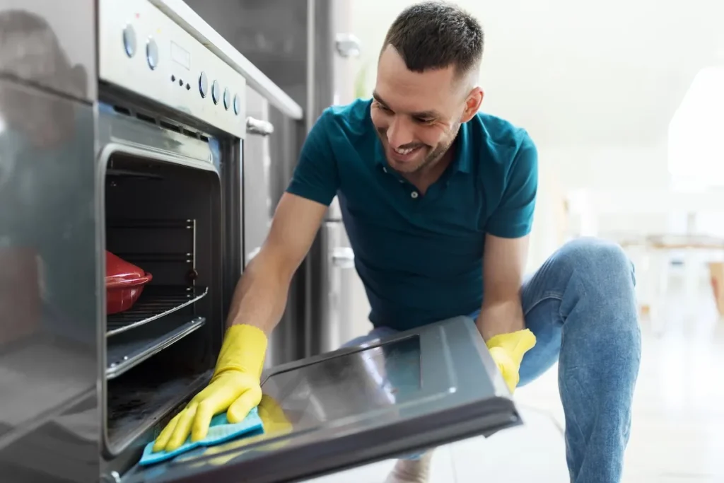 man cleaning oven Deposit