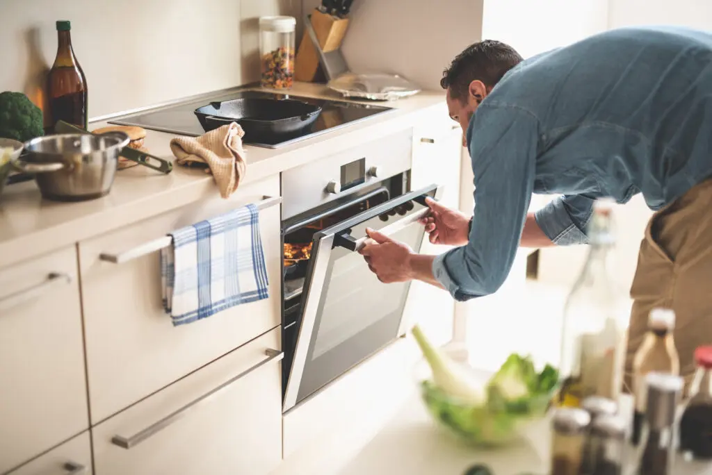 man opening oven