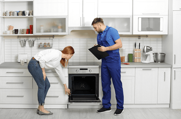 woman and man in front of the oven